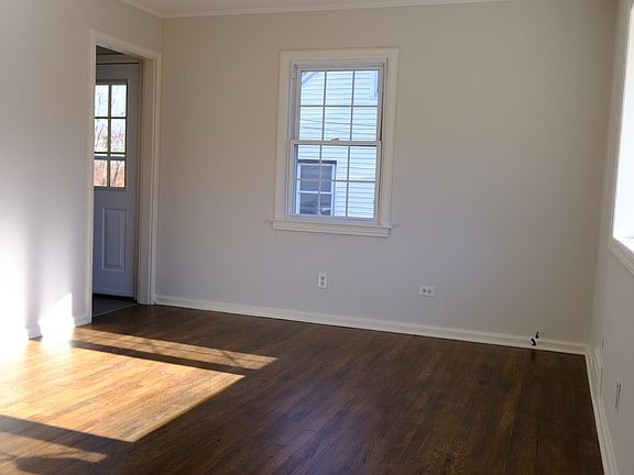 Living room to side door and kitchen