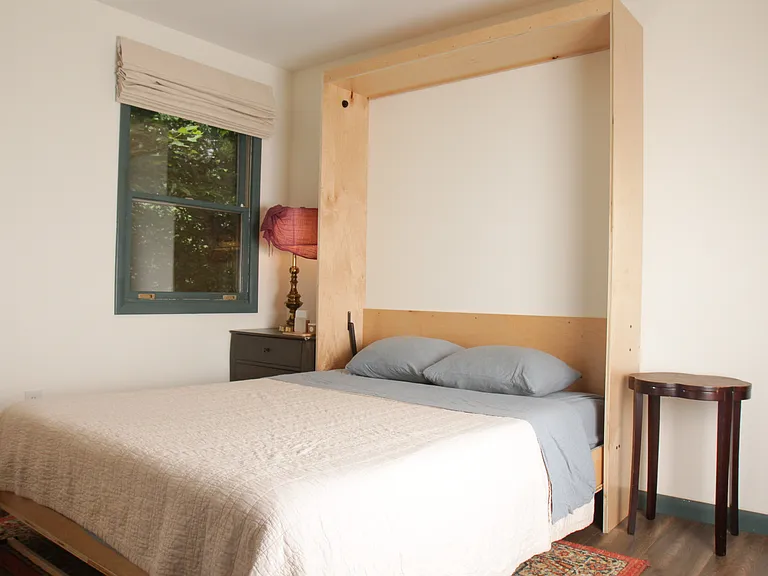 Second bedroom with built in queen murphy bed framing