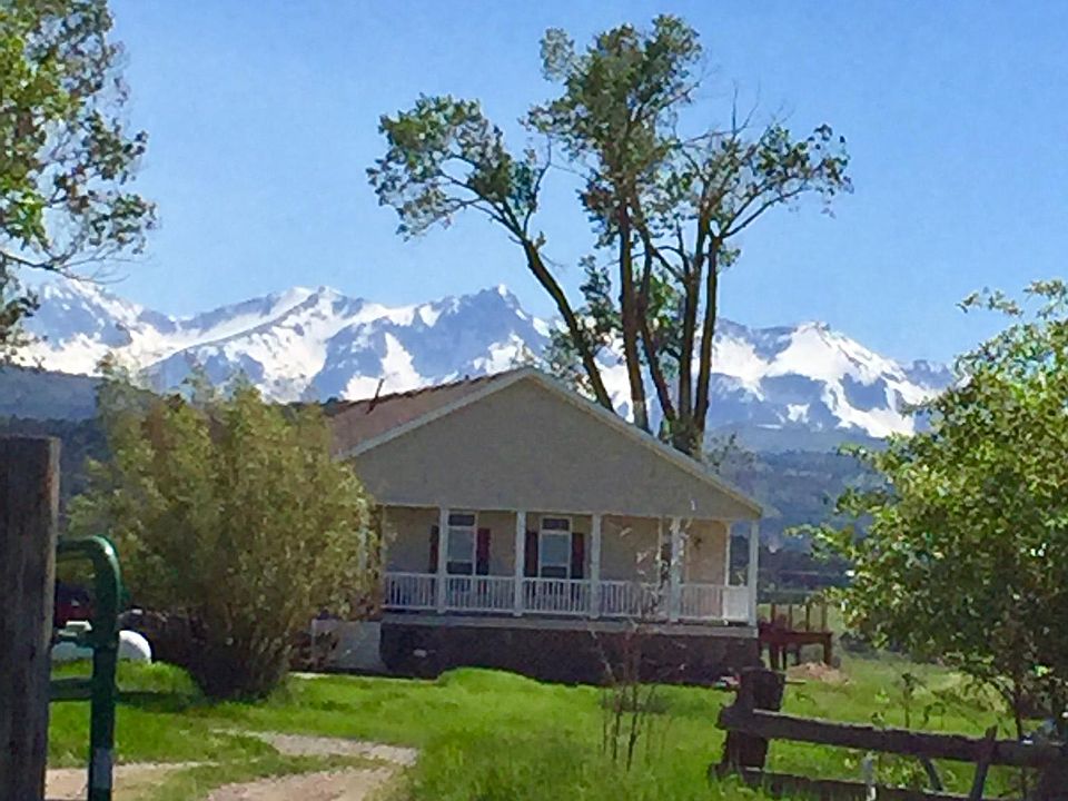 House with Sneffels range in background