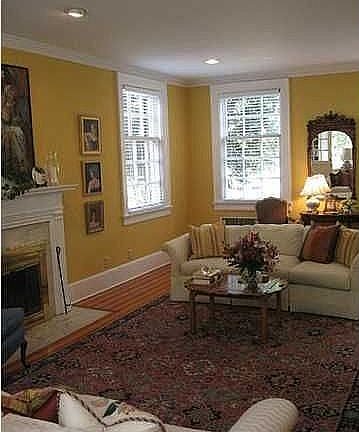 Formal living room has built-in bookshelves and access to sun porch
