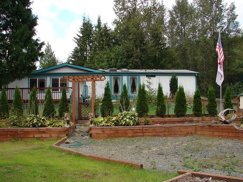 Front of the home as you drive in. Large decks surround the home with steps le