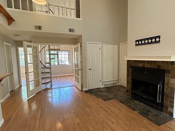 Two white doors - in-unit laundry on left, HVAC on right (door to unit is there too)