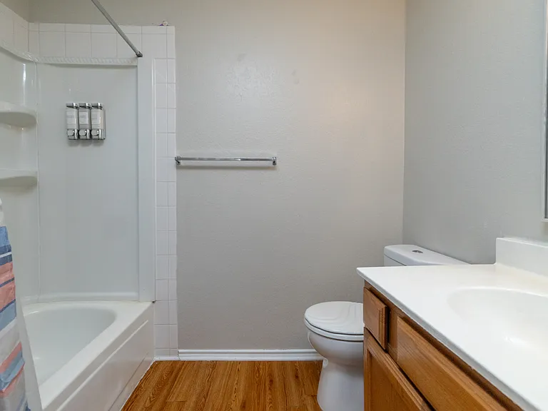 Upstairs Bathroom 2 includes a tub/shower combo, cabinet sink with mirror, and is stocked with soap, shampoo, and conditioner for your stay.