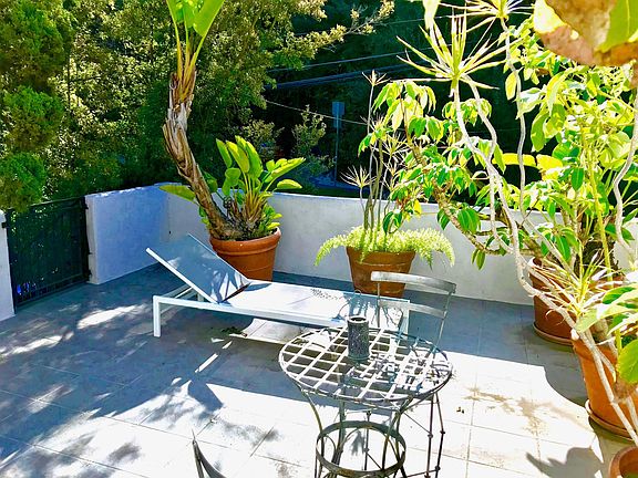 Sun-drenched sundeck has views of the Hollywood Hills and is