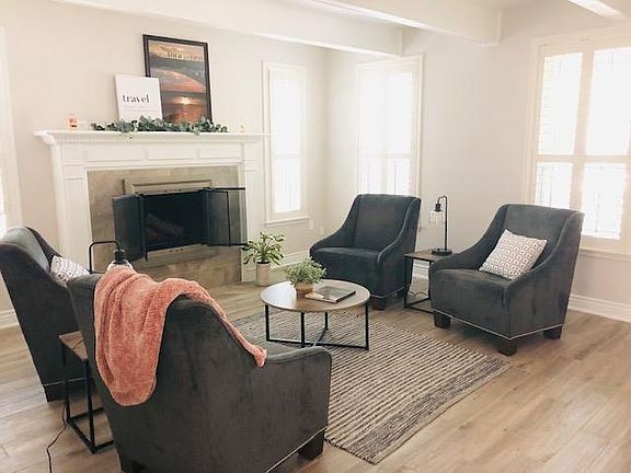 Formal living room/sitting room with wood burning fireplace right off the entry.