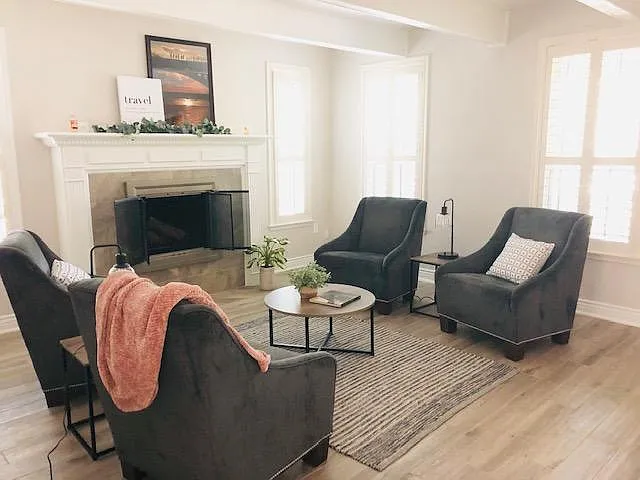 Formal living room/sitting room with wood burning fireplace right off the entry.