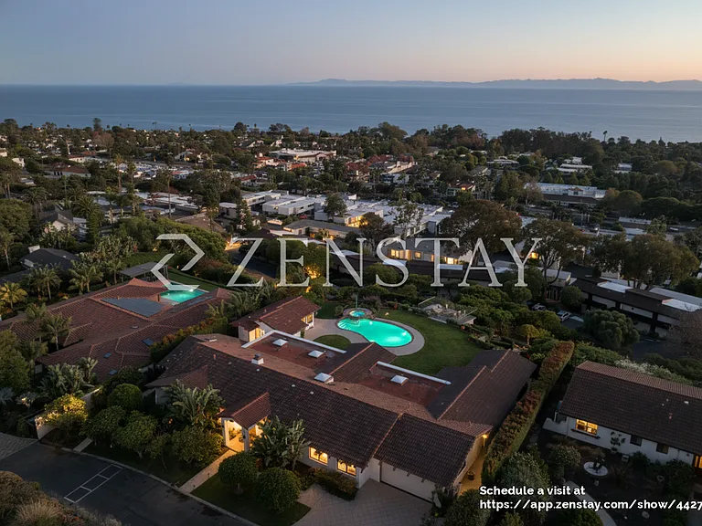 Stunning nighttime aerial highlighting the estate and illuminated grounds