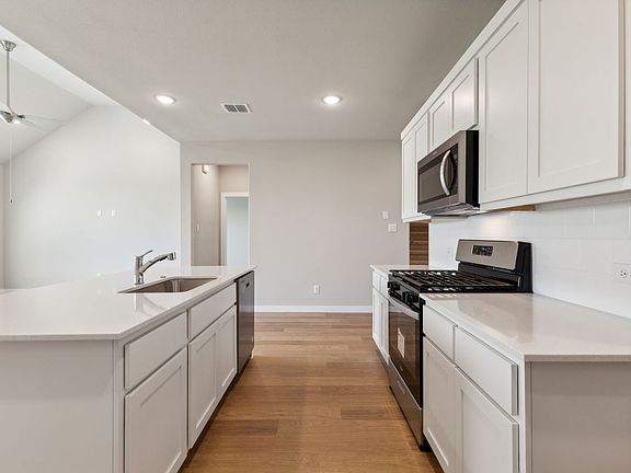 Kitchen in the Masters home plan by Trophy Signature Homes - REPRESENTATIVE PHOTO
