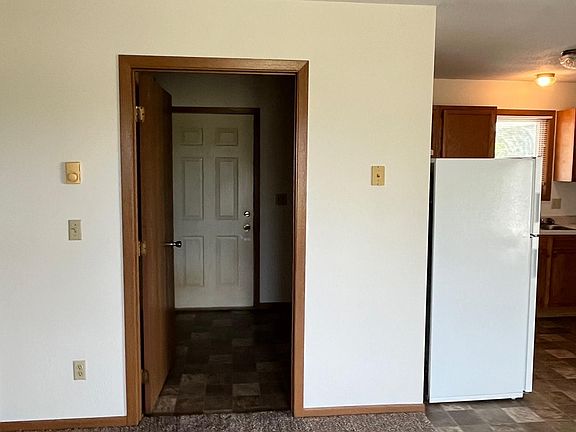 Enters into living room area. Kitchen and front entrance to the right.