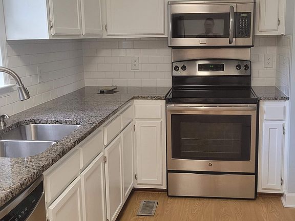 Recently updated kitchen with granite coutertops and tile backsplash.