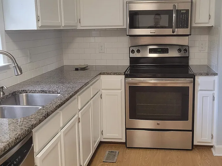 Recently updated kitchen with granite coutertops and tile backsplash.