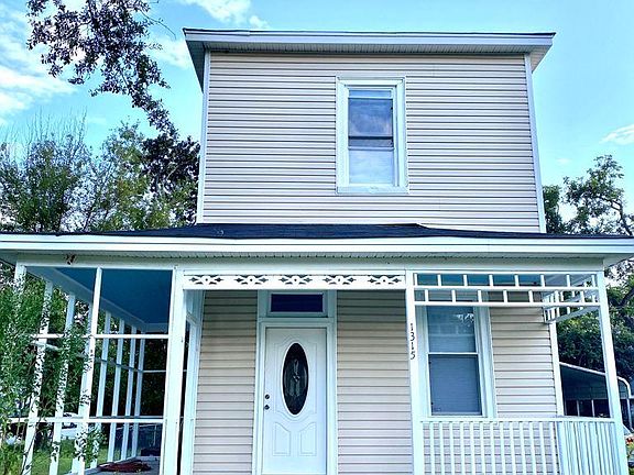 Front view: yellow house with blue skies