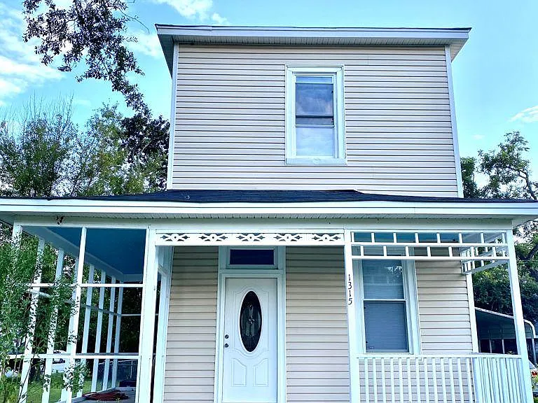 Front view: yellow house with blue skies