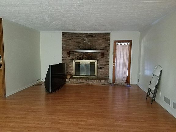 Livingroom with new fireplace screen (not shown). Tenant items to be removed prior to move in.