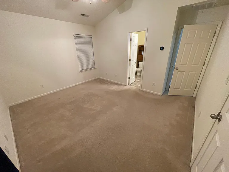 Master Bedroom with master bathroom, walk in closet, and personal smart thermostat for room..