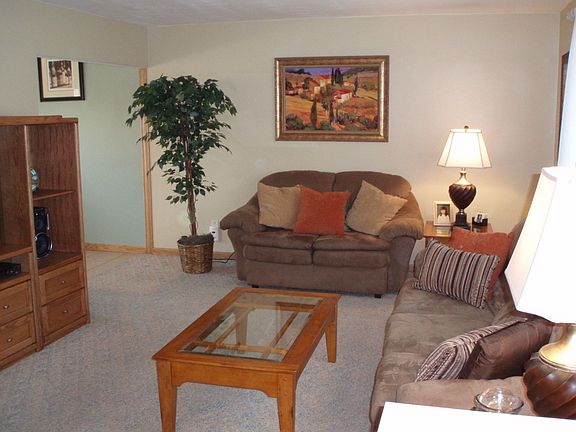 Beautiful, freshly painted livingroom opens with two doorways to the kitchen.