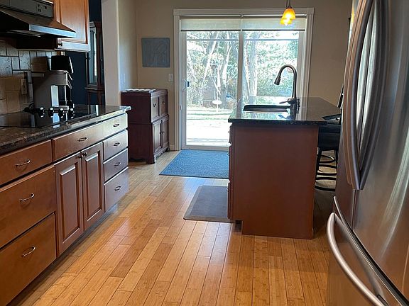 Fully stocked kitchen with sliding glass door to backyard and deck