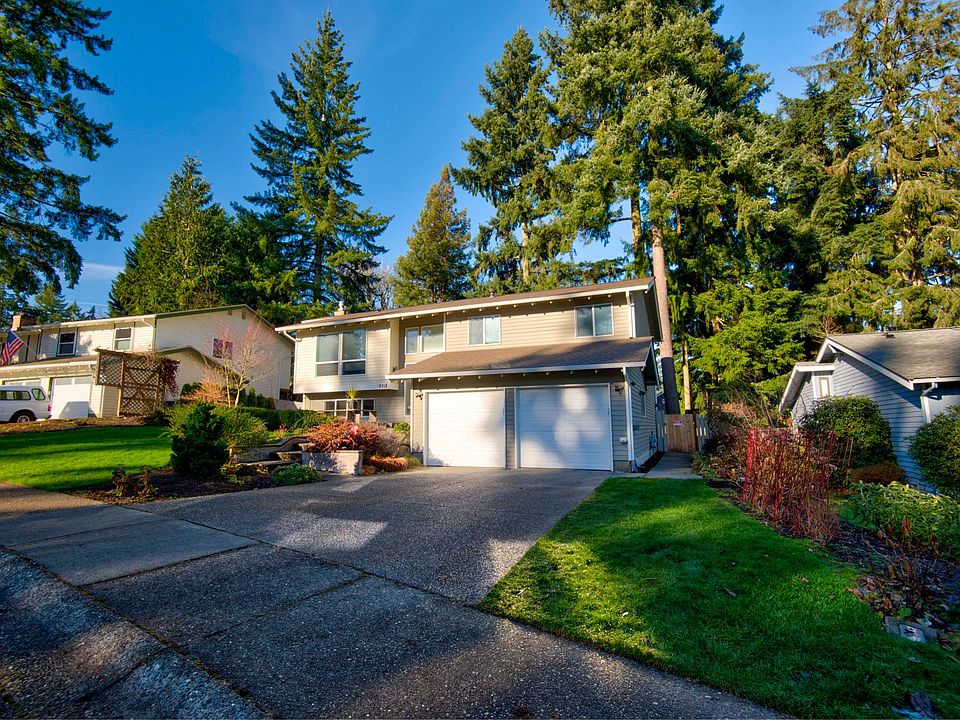 Front of home with sidewalk to apartment on right side of home