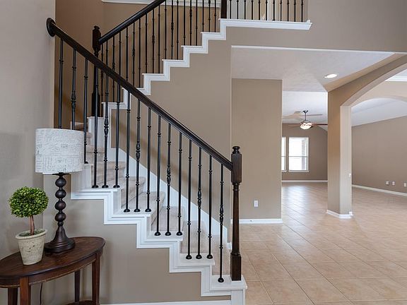 A beautiful wrought iron staircase leads to the upstairs game room!