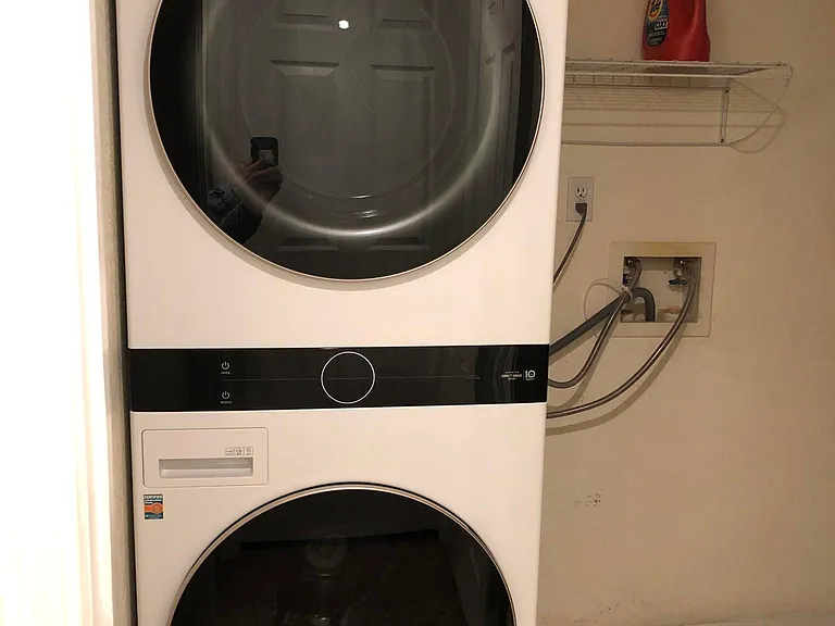 Lower floor laundry room with modern stackable LG washer/dryer