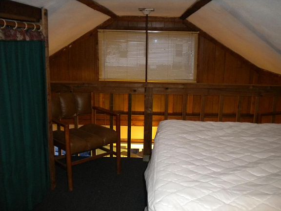 Bedroom with cloth closet and 2 chairs and dresser and chest, double bed and all the linens and blankets