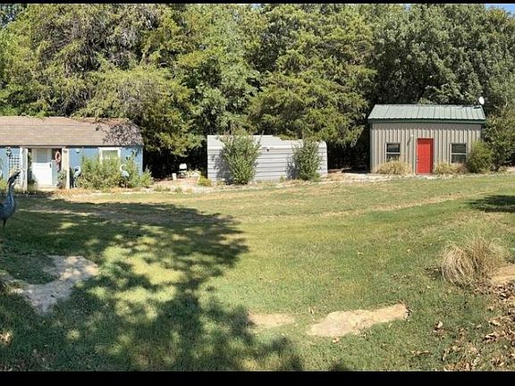 cottage with orange door, picnic table, firepit