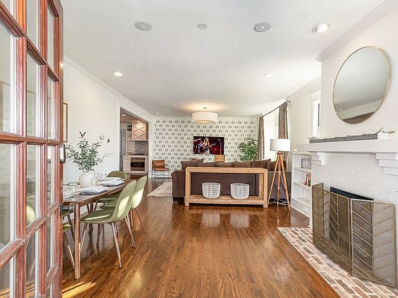 Open-concept living and dining area with hardwood floors and natural light throughout