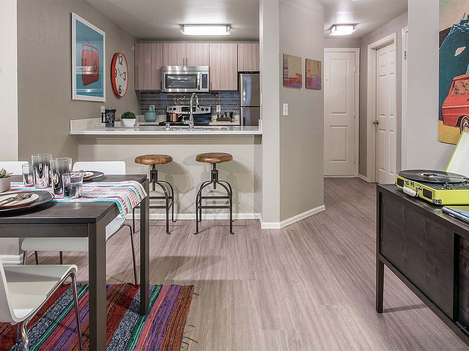 Apartment Kitchen with Stainless Steel Appliances and Dining room and with wood flooring.