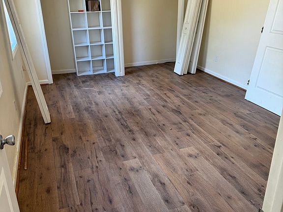 Spacious bedroom with ample closet space (doors are back on closet since photo taken). Newly installed engineered wood flooring.