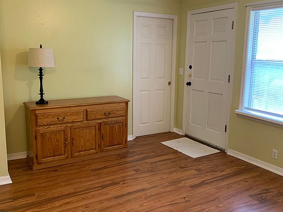 Sitting room area, separated from kitchen area by half wall. Fits loveseat and recliner or chair