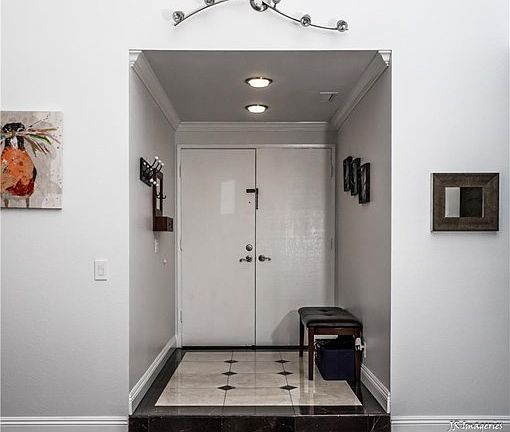 Double-door entry with marble flooring