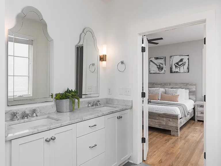 Full Bathroom connected to bedroom 1 with double vanity, shower, and large bathtub.