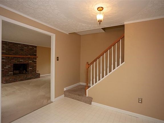The large foyer will greet you upon entry, off to the left is the formal living room featuring a fireplace and a lovely bay wind