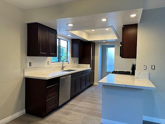 Kitchen with dishwasher and a one foot deep sink.