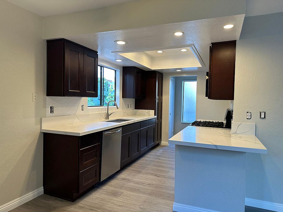 Kitchen with dishwasher and a one foot deep sink.
