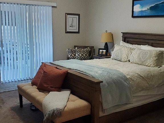 Master Bedroom with Queen Bed, sliding doors lead out to rear patio.