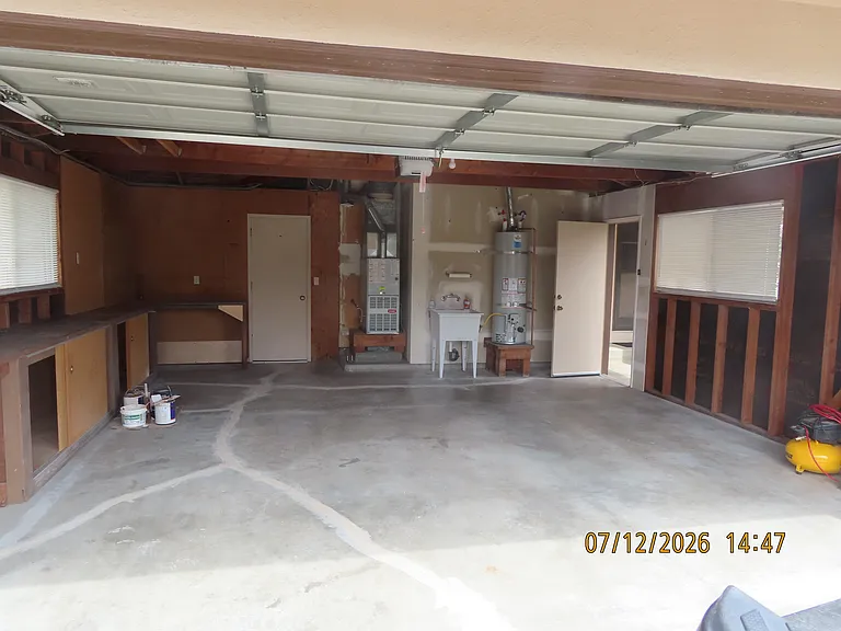 Large double car Garage with storage and work bench.