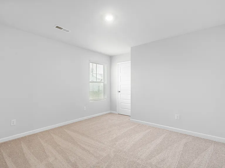 Upstairs bedroom 3 with ceiling fan.