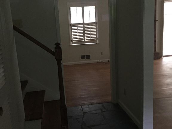 Entrance hall looking into living area; stairs to upper leve