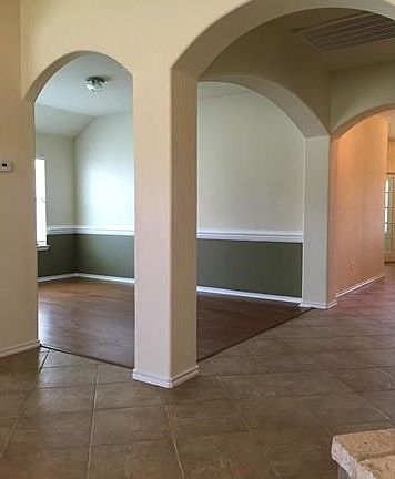 Beautiful Archways leading down the entryway into the dining room, living area and kitchen
