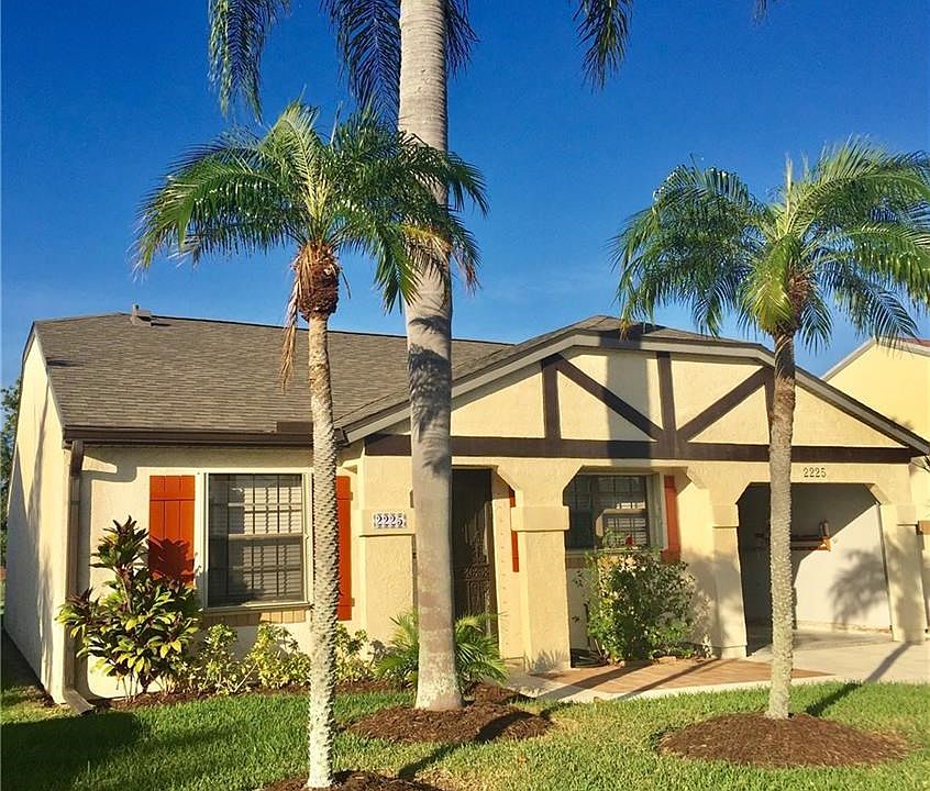 FRONT EXTERIOR OF THIS CHARMING & UPDATED VILLA.  AUTOMATIC GARAGE DOOR OPENER AND NEW ROOF!