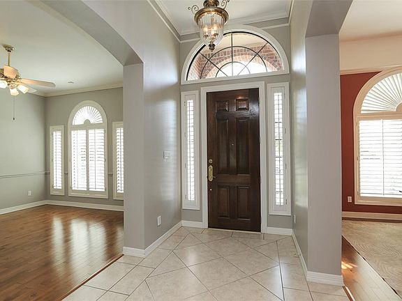 Both the living and dining rooms have wood floors and plantation shutters