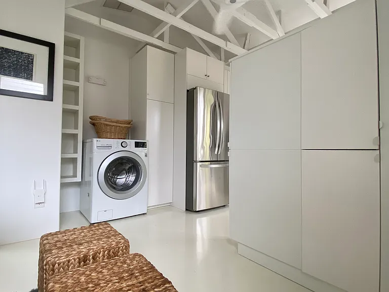 Washer unit with retractable clothesline and lots of closet options.