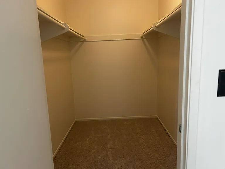 Primary bedroom walk in closet