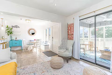 View from living area to dining space. Dining area has round table that seats 4 and chest