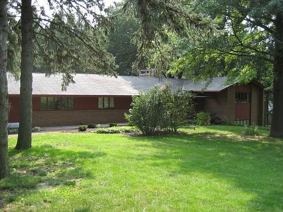 Great front yard with grown trees and professional landscape.