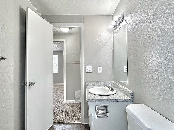 Gray-toned bathroom with modern lighting and updated vanity.