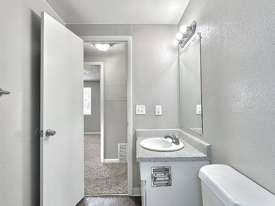 Gray-toned bathroom with modern lighting and updated vanity.