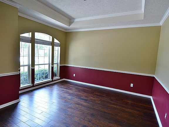 Entry to the home is the formal dining room nicely accented with color and tray ceilings.