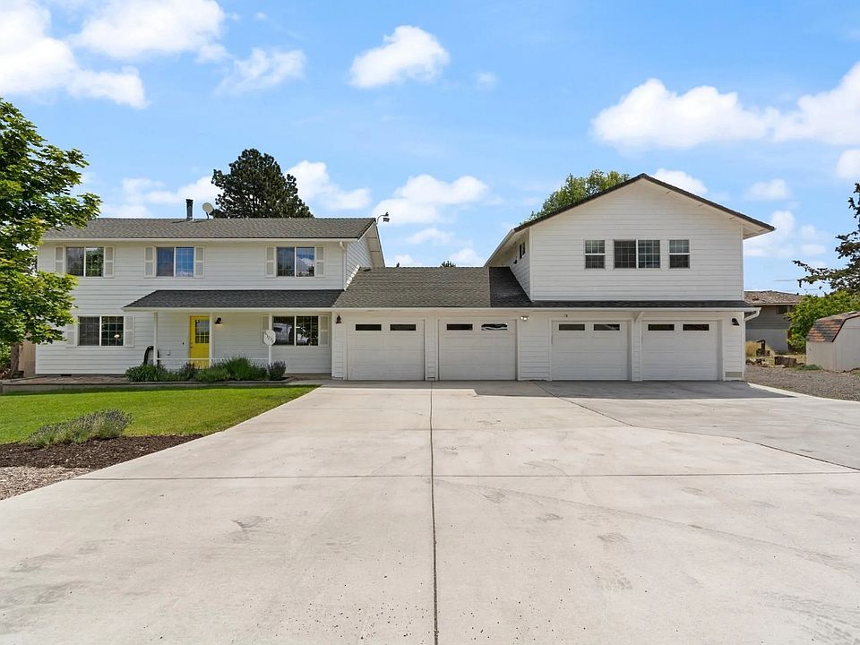 This home has a huge driveway next to a large gravel area where the owners' RV is currently stored.